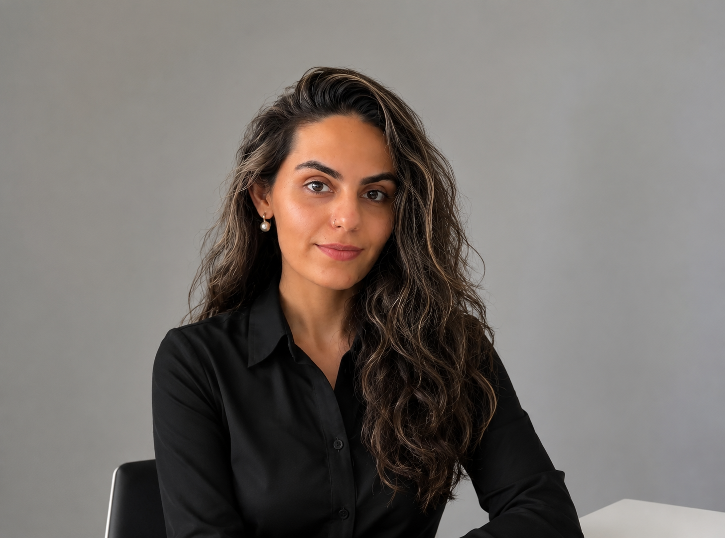 Büşra Nur seated in a black shirt at a desk